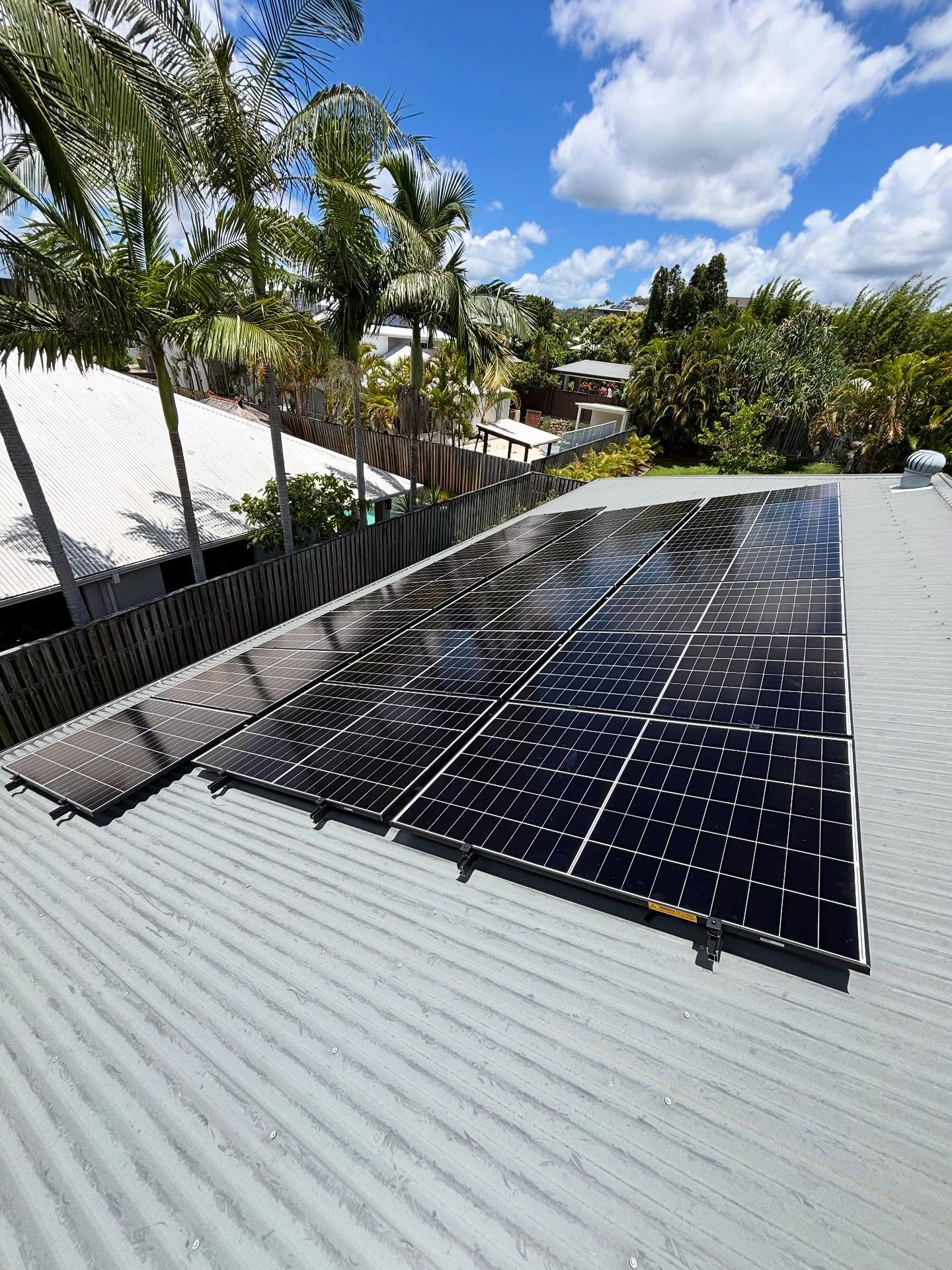 Solar panels on grey colorbond roof, coastal suburb